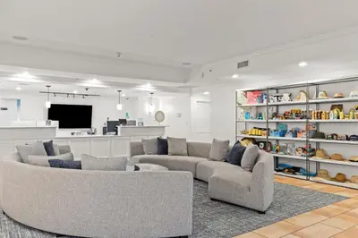 a living room with two couches and a tv at Grand Panama Beach Resort by Panhandle Getaways in Panama City Beach