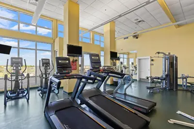 a gym with treadmills and elliptical machines at Grand Panama Beach Resort by Panhandle Getaways in Panama City Beach