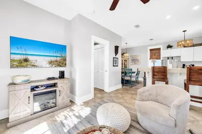a living room with a fireplace and a tv at Blue Sky Bungalow 156 in Seagrove Beach