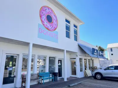a donut shop with a donut sign on the side of it at Blue Sky Bungalow 156 in Seagrove Beach