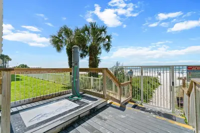 a wooden deck with a fence and a gate at Long Beach Resort by Panhandle Getaways in Panama City Beach