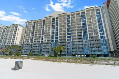 a large apartment building on the beach with a beach at Long Beach Resort by Panhandle Getaways in Panama City Beach
