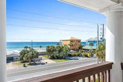 a balcony with a view of the ocean at Glory Daze Beach House by Panhandle Gateways in Sunnyside