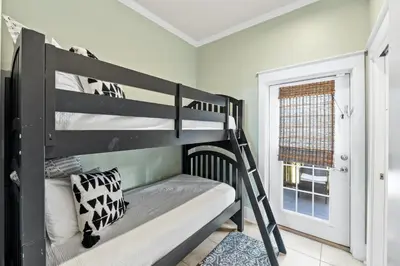 a bedroom with two bunk beds and a window at Glory Daze Beach House by Panhandle Gateways in Sunnyside