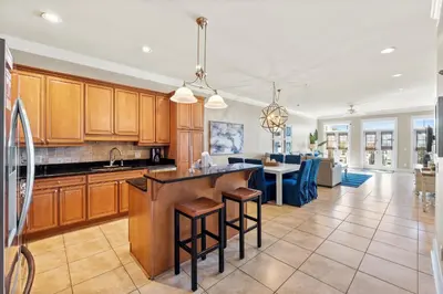 a large kitchen with wooden cabinets and a kitchen island at Glory Daze Beach House by Panhandle Gateways in Sunnyside