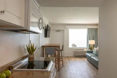a kitchen and living room with a couch and a table at Radisson Beachfront Hotel - Panama City Beach in Panama City Beach