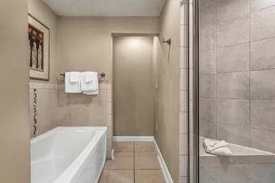 a bathroom with a white tub and a shower at Grand Panama 1-303 in Panama City Beach