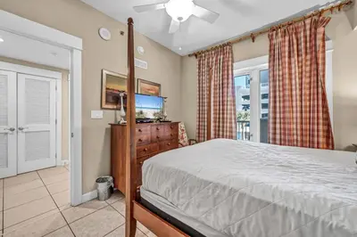 a bedroom with a bed and a flat screen tv at Grand Panama 1-303 in Panama City Beach