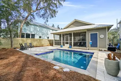 a swimming pool in front of a house at 30A Beach House - Mar Chiquita in Watersound Beach