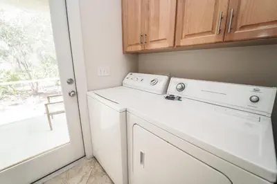 a white laundry room with a washer and dryer at 30A Beach House - Mar Chiquita in Watersound Beach