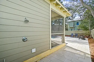 a sliding glass door on the side of a house at 30A Beach House - Mar Chiquita in Watersound Beach