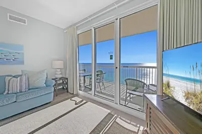 a living room with a view of the ocean at Sunrise Beach #2411 in Panama City Beach