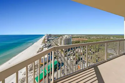 a balcony with a view of the beach and the ocean at Sunrise Beach #2411 in Panama City Beach