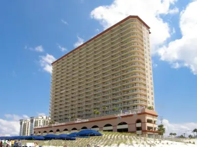 a large building on the beach with umbrellas in front of it at Sunrise Beach #2411 in Panama City Beach