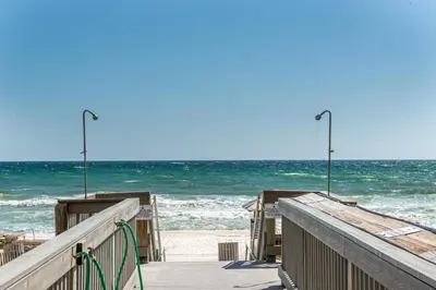 a wooden pier with the ocean in the background at Sunrise Beach #2411 in Panama City Beach