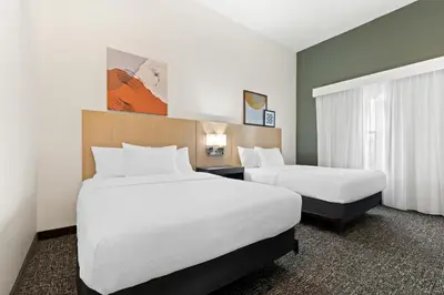 a hotel room with two beds and a window at Spark by Hilton Panama City Beach in Panama City Beach