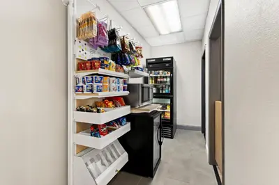 a walk in pantry with a refrigerator filled with food at Spark by Hilton Panama City Beach in Panama City Beach