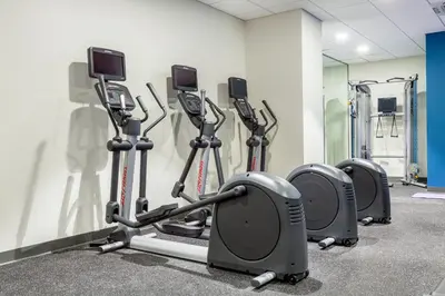 a row of cardio machines in a gym at Holiday Inn Express & Suites Panama City Beach - Beachfront by IHG in Panama City Beach