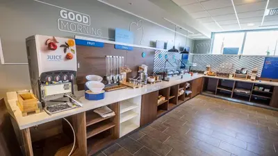 a large kitchen with a counter with food items at Holiday Inn Express & Suites Panama City Beach - Beachfront by IHG in Panama City Beach