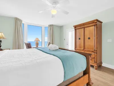 a bedroom with a large bed and a large window at Emerald Beach 2225 in Panama City Beach