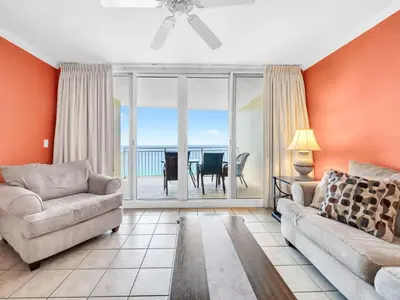 a living room with a couch and a view of the ocean at Emerald Beach 2225 in Panama City Beach