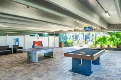 a large room with two ping pong tables in it at Emerald Beach 2225 in Panama City Beach