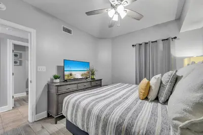 a bedroom with a bed and a flat screen tv at Majestic Beach Towers 2-2003 in Panama City Beach