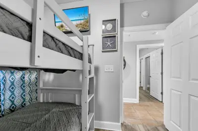 a bedroom with a bunk bed and a staircase at Majestic Beach Towers 2-2003 in Panama City Beach