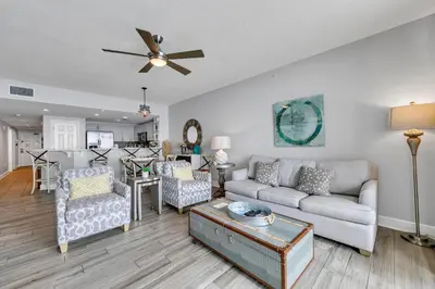 a living room with a couch and a ceiling fan at Majestic Beach Towers 2-2003 in Panama City Beach