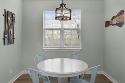 a white dining room with a white table and chairs at The Bungalows at Seagrove 114 in Seagrove Beach