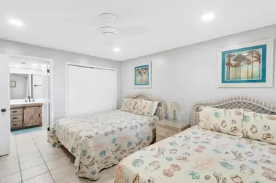a bedroom with two beds and a bathroom at Mariner West 205 in Panama City Beach