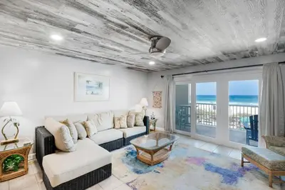 a living room with a couch and a table at Mariner West 205 in Panama City Beach