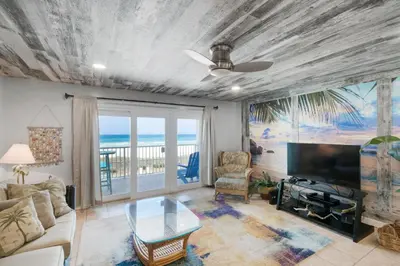 a living room with a view of the ocean at Mariner West 205 in Panama City Beach