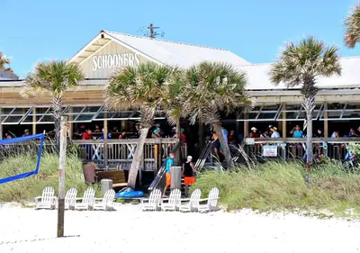a building with palm trees in front of a playground at Mariner West 205 in Panama City Beach