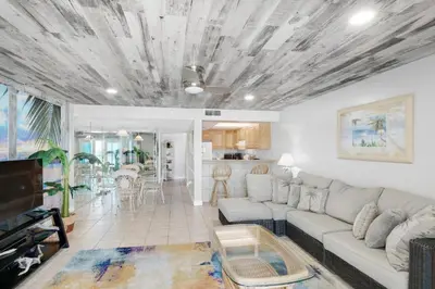 a living room with a couch and a table at Mariner West 205 in Panama City Beach