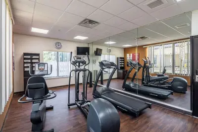 a fitness room with treadmills and elliptical machines at Comfort Suites in Panama City Beach