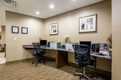 an office with a desk with two chairs and a computer at Comfort Suites in Panama City Beach