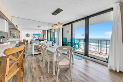 a kitchen and dining room with a view of the ocean at Edgewater Tower 2-611 in Panama City Beach