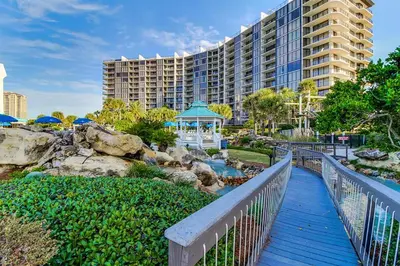 a walkway leading to a resort with a gazebo at Edgewater Tower 2-611 in Panama City Beach