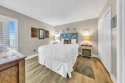 a bedroom with a large white bed and a window at Edgewater Tower 2-611 in Panama City Beach
