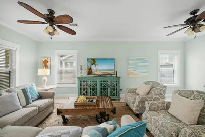 a living room with two couches and a ceiling fan at 30A Beach House - Sanibel in Seagrove Beach