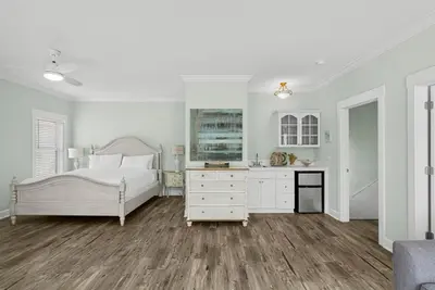 a white bedroom with a bed and a dresser at 30A Beach House - Sanibel in Seagrove Beach