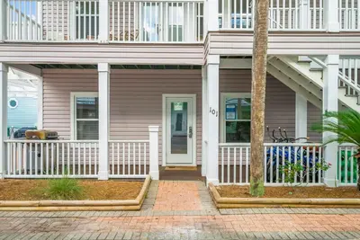 a house with a white fence and a porch at 30A Beach House - Sanibel in Seagrove Beach