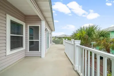 a balcony of a house with white railings at 30A Beach House - Sanibel in Seagrove Beach