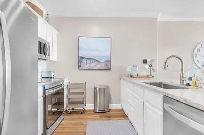 a kitchen with white cabinets and a sink at Ocean Reef 1708 in Panama City Beach