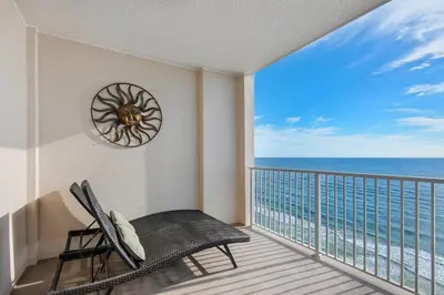 a balcony with a chair and a view of the ocean at Ocean Reef 1708 in Panama City Beach