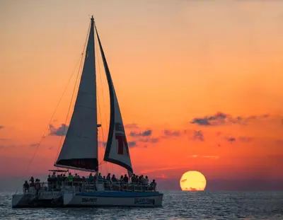 a group of people on a sailboat at sunset at Ocean Reef 1708 in Panama City Beach