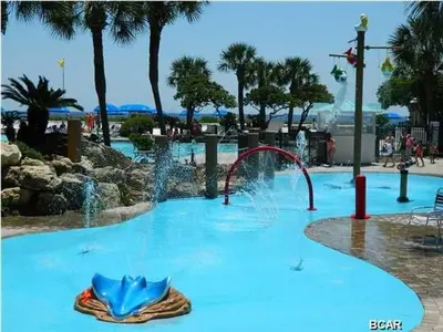 a swimming pool with a water fountain in a park at Edgewater Beautiful 2 bedroom 2 bath! in Panama City Beach