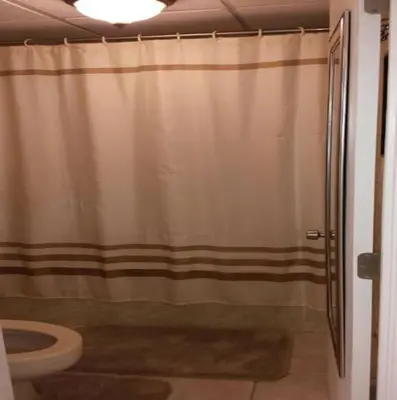 a bathroom with a shower curtain and a toilet at Edgewater Beautiful 2 bedroom 2 bath! in Panama City Beach
