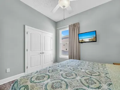a bedroom with a bed and a window at Vista del Mar I Rest-A-While 201 in Panama City Beach